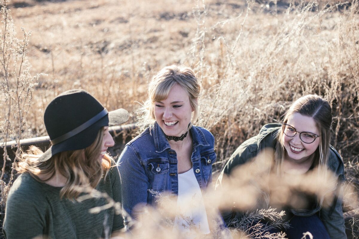 frauen lachen draußen sitzen